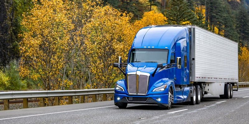 blue semi truck with trailer
