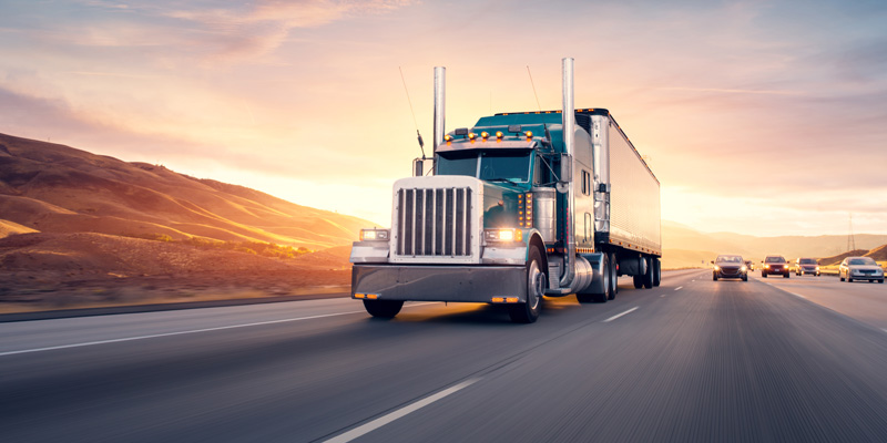 blue semi truck on the highway